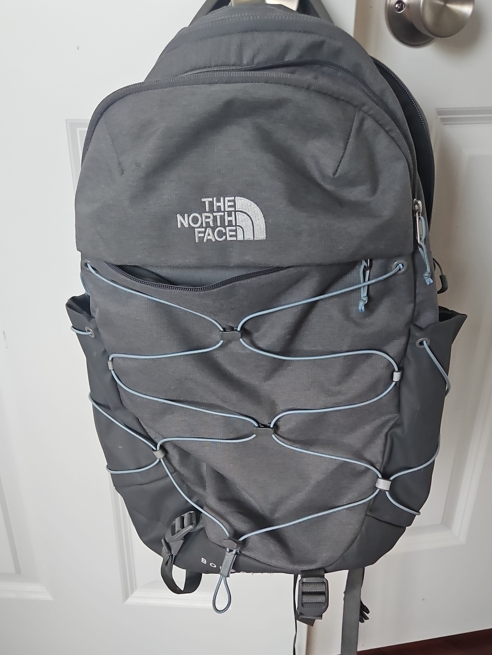 The North Face Grey Backpack with Light Blue Bungee Cord